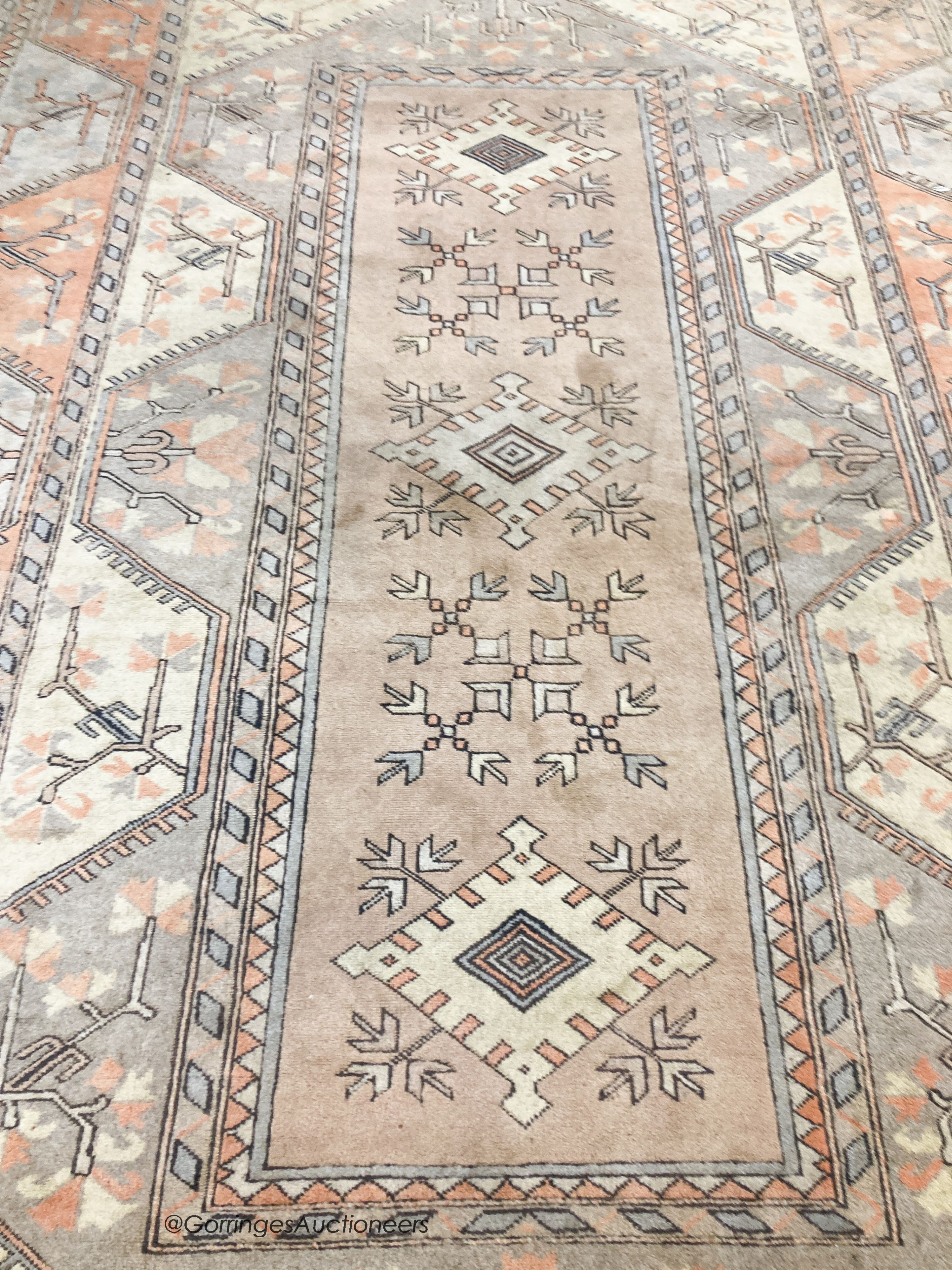 A large Caucasian Turkish design fawn ground carpet, 420 x 300cm